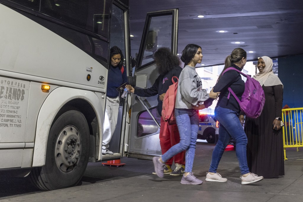 Migrants arrive after traveling on a bus from Del Rio, Texas, at the Port Authority Bus Terminal in New York, US, on Saturday, May 13, 2023