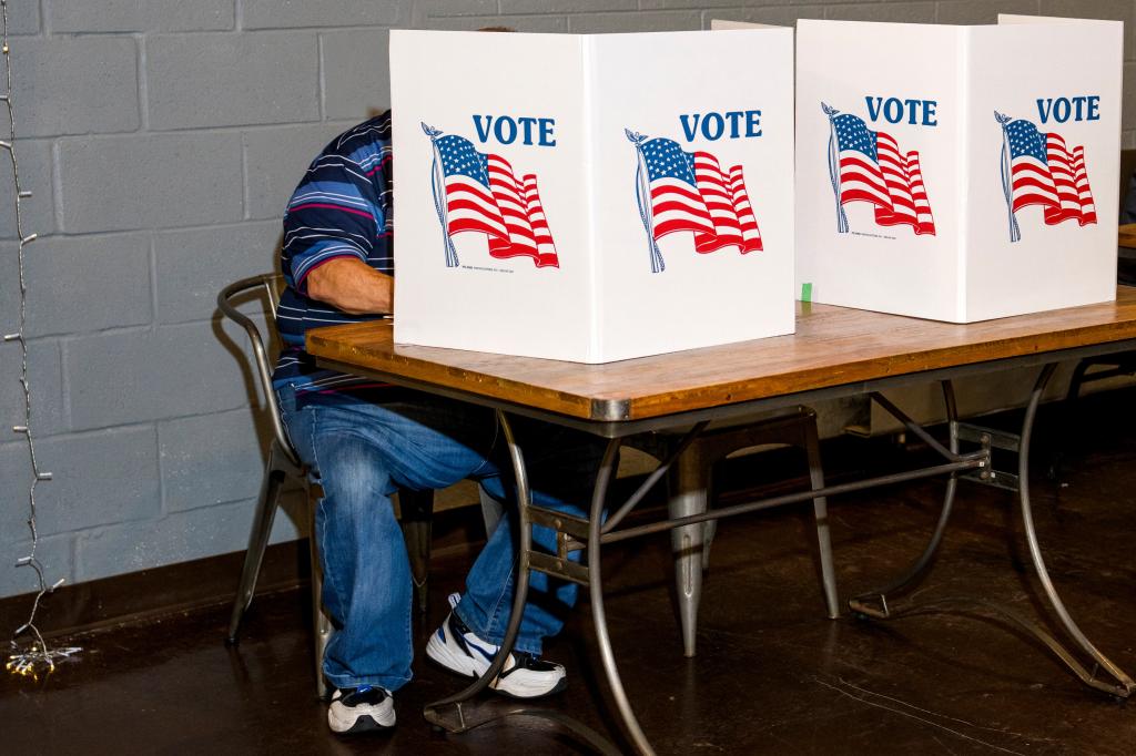 A voter fills out their ballot at a polling station at Renaissance Vineyard Church in Ferndale, Michigan, US, on Tuesday, Aug. 6, 2024.