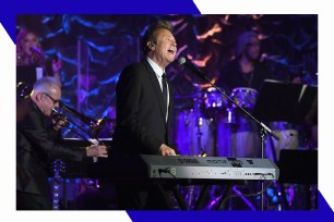 Chicago frontman Robert Lamm wails while playing keyboards.