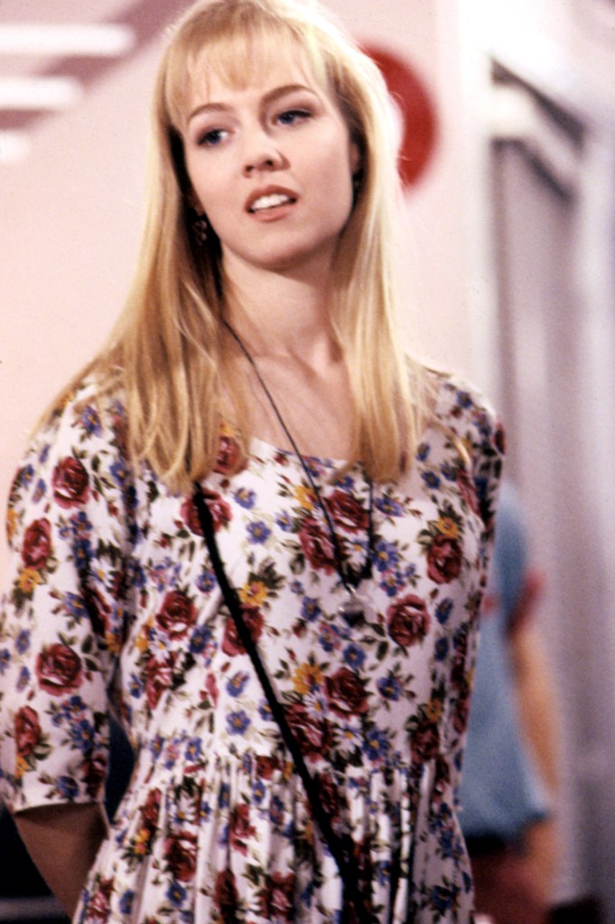 Jennie Garth with blonde hair wearing a floral shirt in a scene from Beverly Hills, 90210