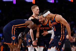 Jalen Brunson #11 of the New York Knicks huddles with Josh Hart #3, Donte DiVincenzo #0, and OG Anunoby #8 of the New York Knicks during the second half against the Philadelphia 76ers in Game Two of the Eastern Conference First Round Playoffs at Madison Square Garden on April 22, 2024 in New York City. The Knicks won 104-101.