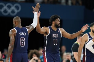 Joel Embiid amongst a group of basketball players in uniform