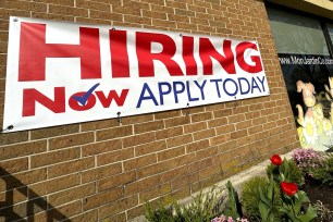 A hiring sign is displayed in Riverwoods, Ill., on April 16, 2024.