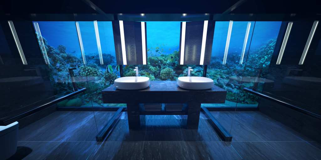 A bathroom in the free-standing, two-level Muraka residence at Conrad Maldives Rangali Island, featuring sinks and a fish tank.