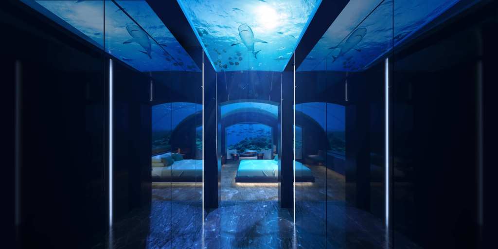 A two-level suite at Conrad Maldives Rangali Island, named THE MURAKA, with one level submerged under the sea showcasing aquatic life.