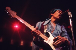 Jimi Hendrix playing guitar at Madison Square Garden.