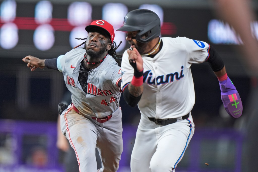 Reds star Elly De La Cruz tags Derek Hill on Aug. 6 during a Reds-Marlins game.