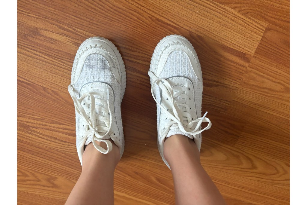 A pair of white shoes on a wooden surface