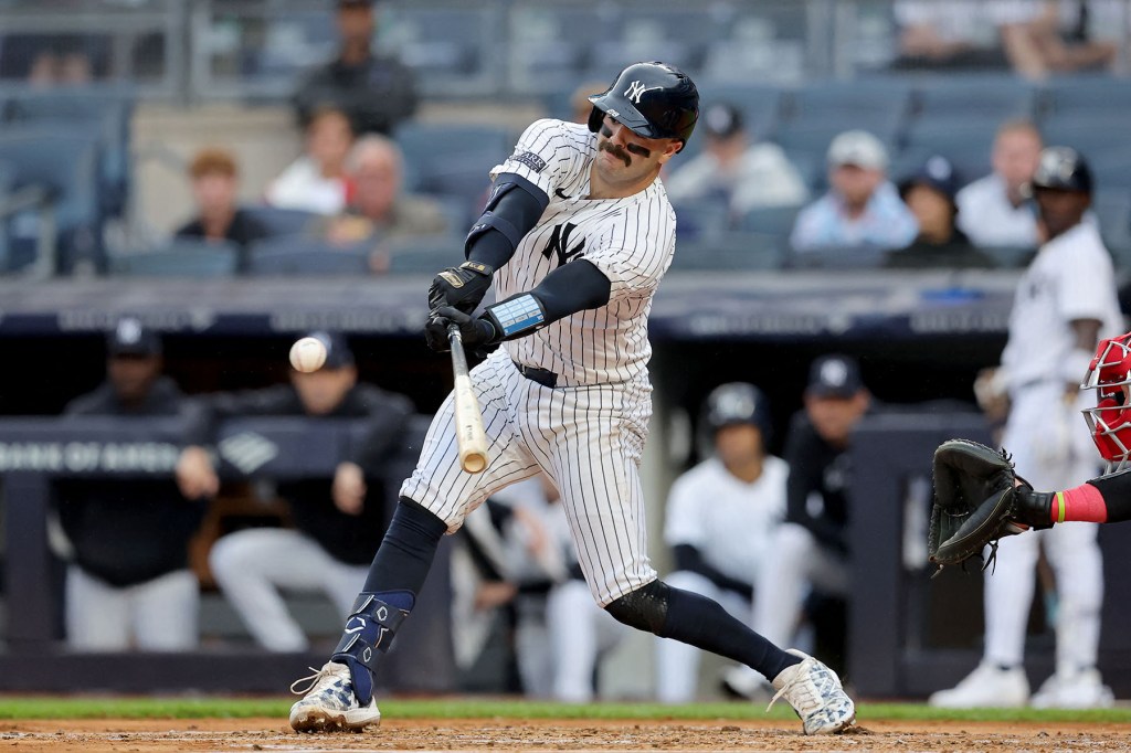 New York Yankees catcher Austin Wells (28) hits an RBI single against the Los Angeles Angels during the first inning at Yankee Stadium.