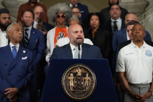 Rev. Al Sharpton, Joe Borelli and Eric Adams at a rally