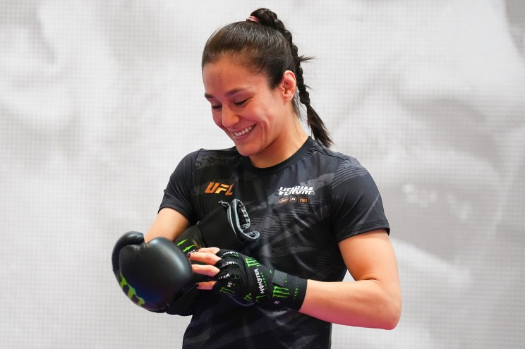 Alexa Grasso, set to face Valentina Shevchenko on Saturday for the third time, puts on her gloves during an open workout session for media at UFC Apex on Sept. 4.