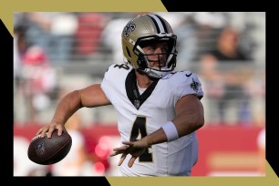 New Orleans Saints quarterback Derek Carr winds up to throw a pass.