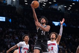 Brooklyn Nets guard Cam Thomas (24) shoots between Detroit Pistons forward Ausar Thompson (9) and guard Cade Cunningham (2) in the second half at Barclays Center, Saturday, Dec. 23, 2023, in Brooklyn, NY.