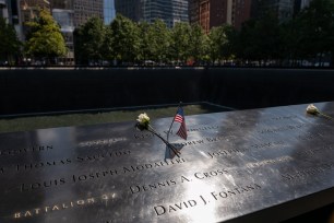 Flower and American flag placed at the September 11 Memorial and Museum in New York City.