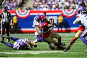 New York Giants running back Devin Singletary (26) runs with the ball as Minnesota Vikings linebacker Blake Cashman (51) defends during the first half at MetLife Stadium.