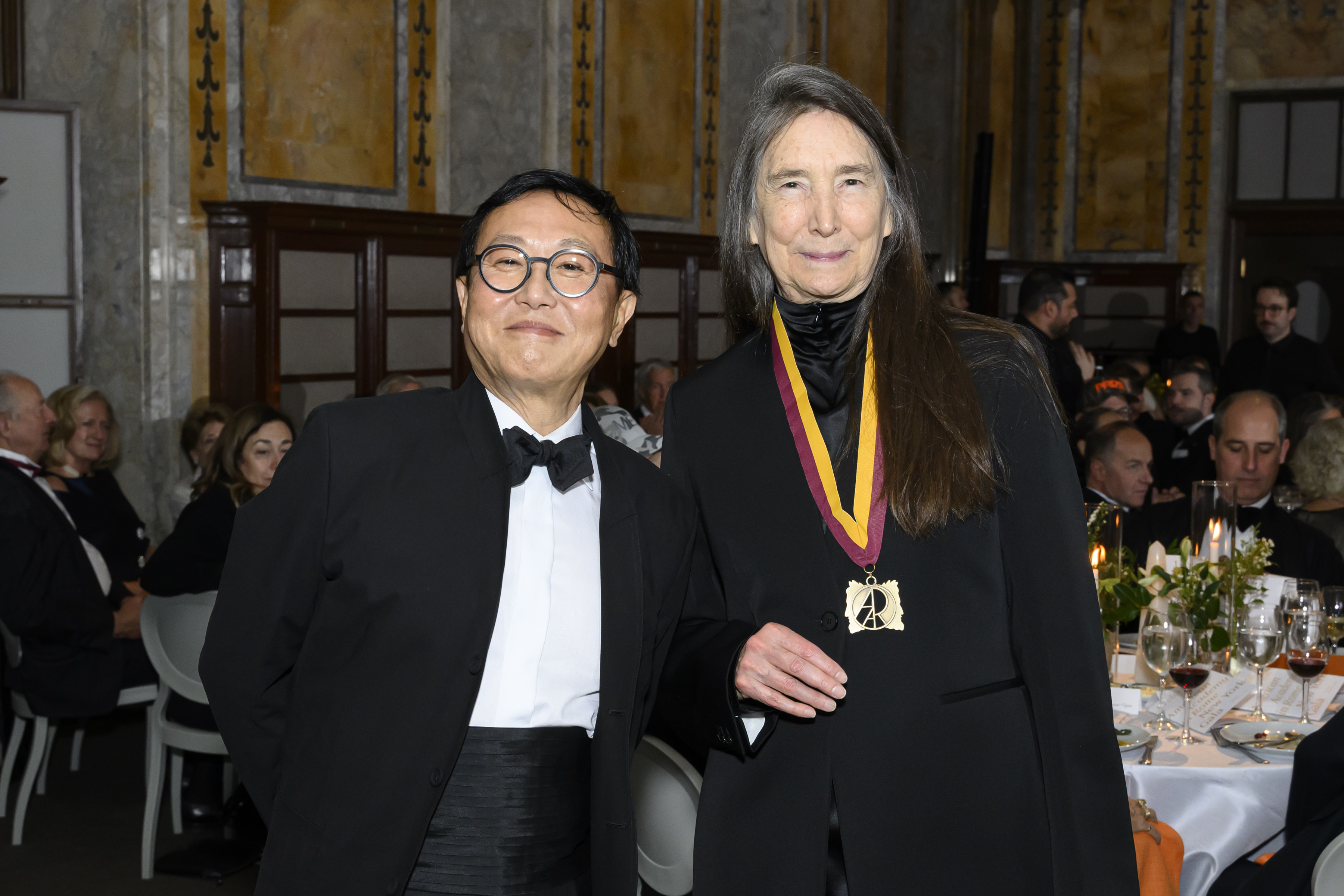 An asian man and a woman elegantly dressed.