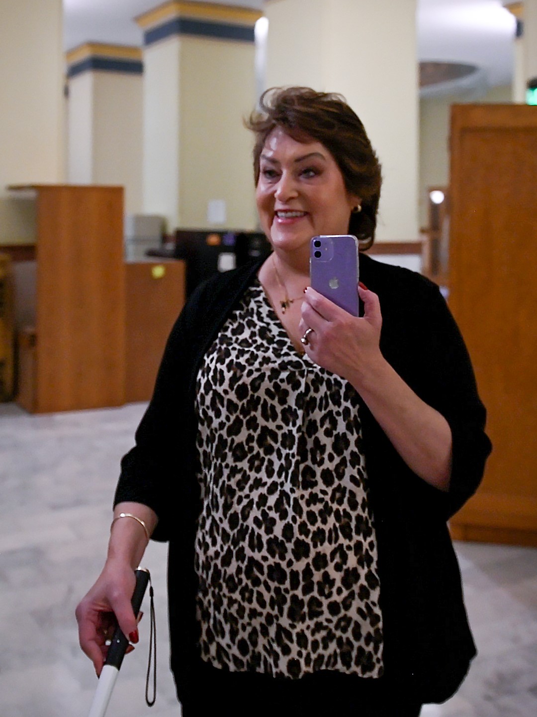 Visitor to the Colorado State Capitol being guided by an Aira agent on her smart phone.