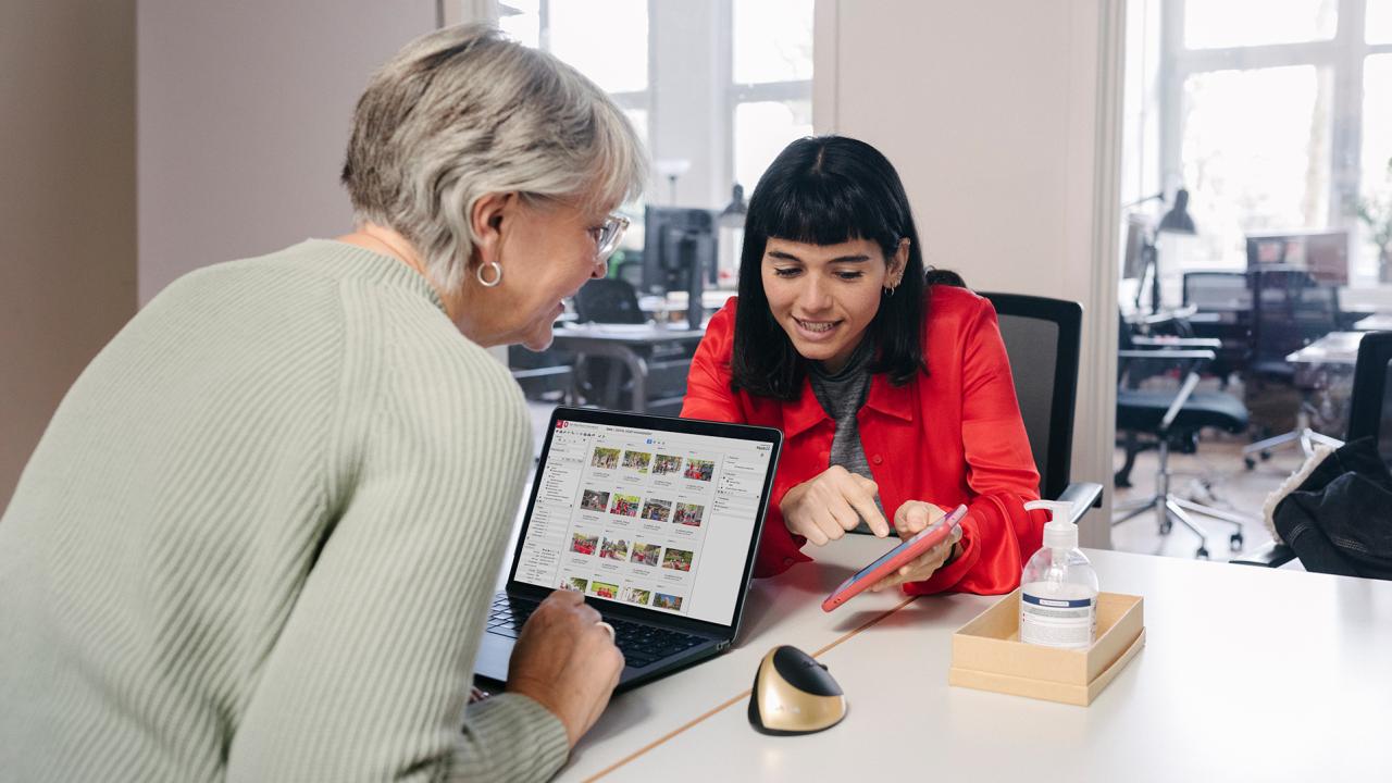 Two people collaborating with laptop