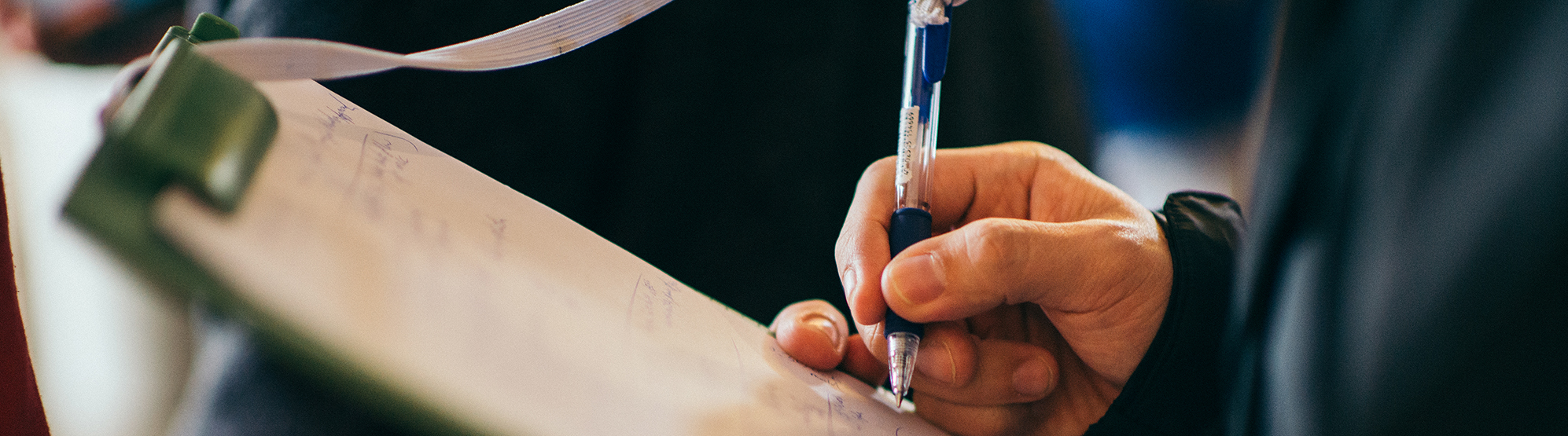 Man writing on clipboard