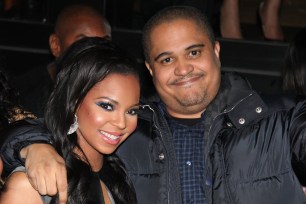 Irv Gotti in black puffy coat holding a drink hugging Ashanti. Couple dated from 2002-2004.