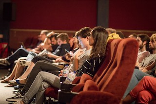 Conference speakers in the first row listening to the talks.