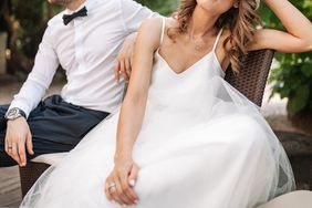 Newlywed coupe sitting on a sofa angry at each other 