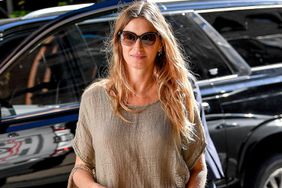 Gisele Bundchen is pictured stepping out in New York City. The Brazilian supermodel carried a Naghedi woven handbag and wore a linen style shirt, jeans, and sandals.