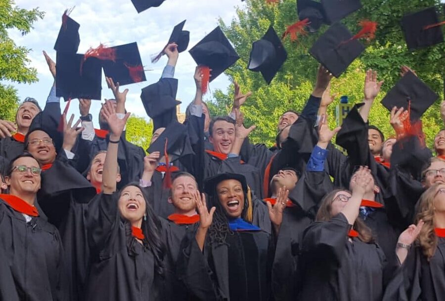 college graduates throw their caps in the air