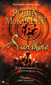 The Book Cover for Sunshine. Red and Black, a chandelier and roof at an artistic angle.