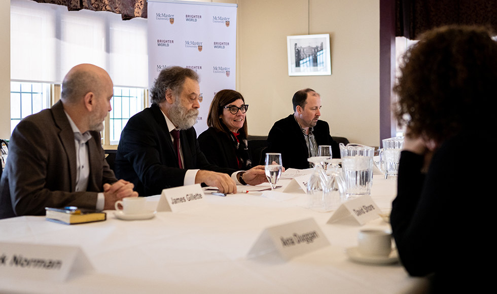 Filomena Tassi and others sitting at a table.