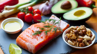 A spread of fresh fish, fruits, vegetables, olive oil, and nuts.