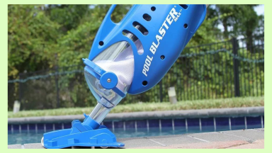 Water tech pool blaster pool vacuum next to an in-ground pool