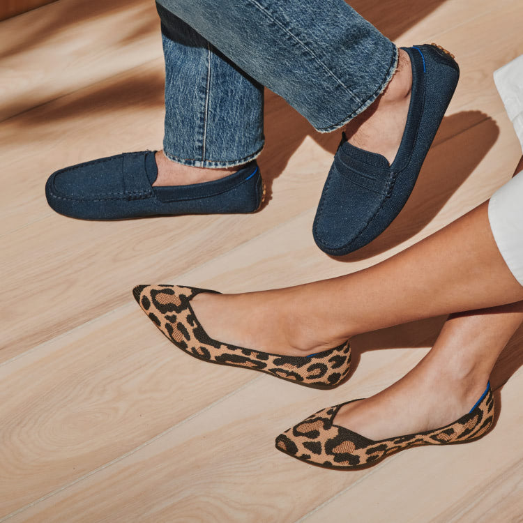 A male model wearing The Driving Loafer in Navy and a female model wearing The Point in Desert Cat.