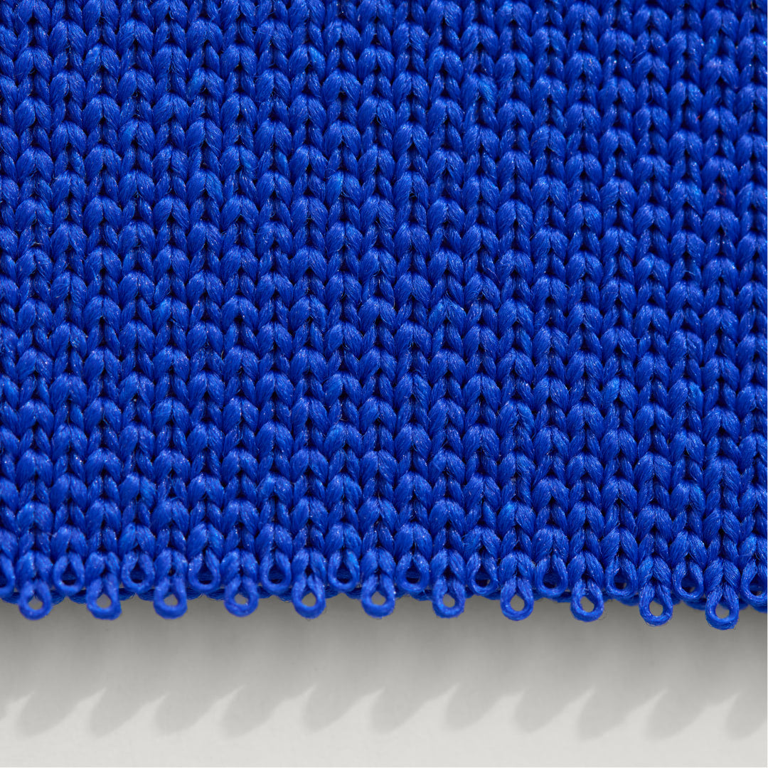 A close up shot of our rPET knit in bright blue.