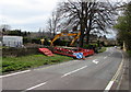 SP1037 : L Lynch excavator at the edge of High Street, Broadway by Jaggery