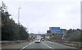 SP1889 : M42 link round approaching footbridge by John Firth