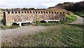 NY0235 : Seats at circular wall at junction of paths near coast by Luke Shaw