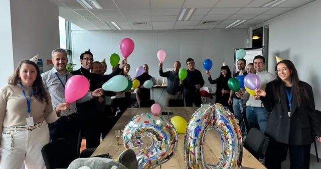 The SensioLabs team celebrating the 20th anniversary of Symfony with balloons