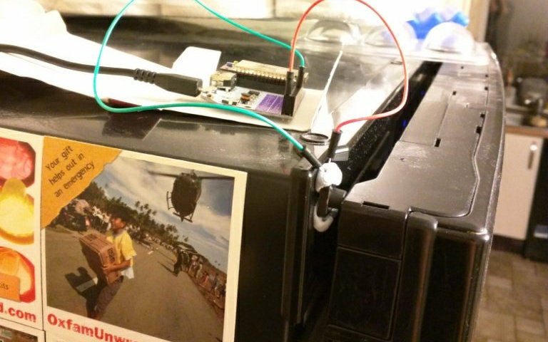 Photo of a fridge with a circuit board and sensors plugged into it.