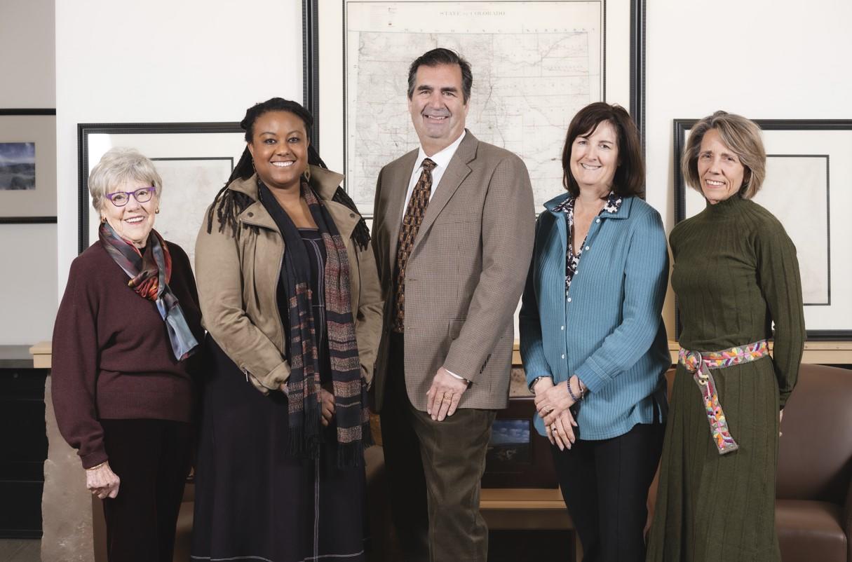 five SLB commissioners pose in front of maps in an office settings