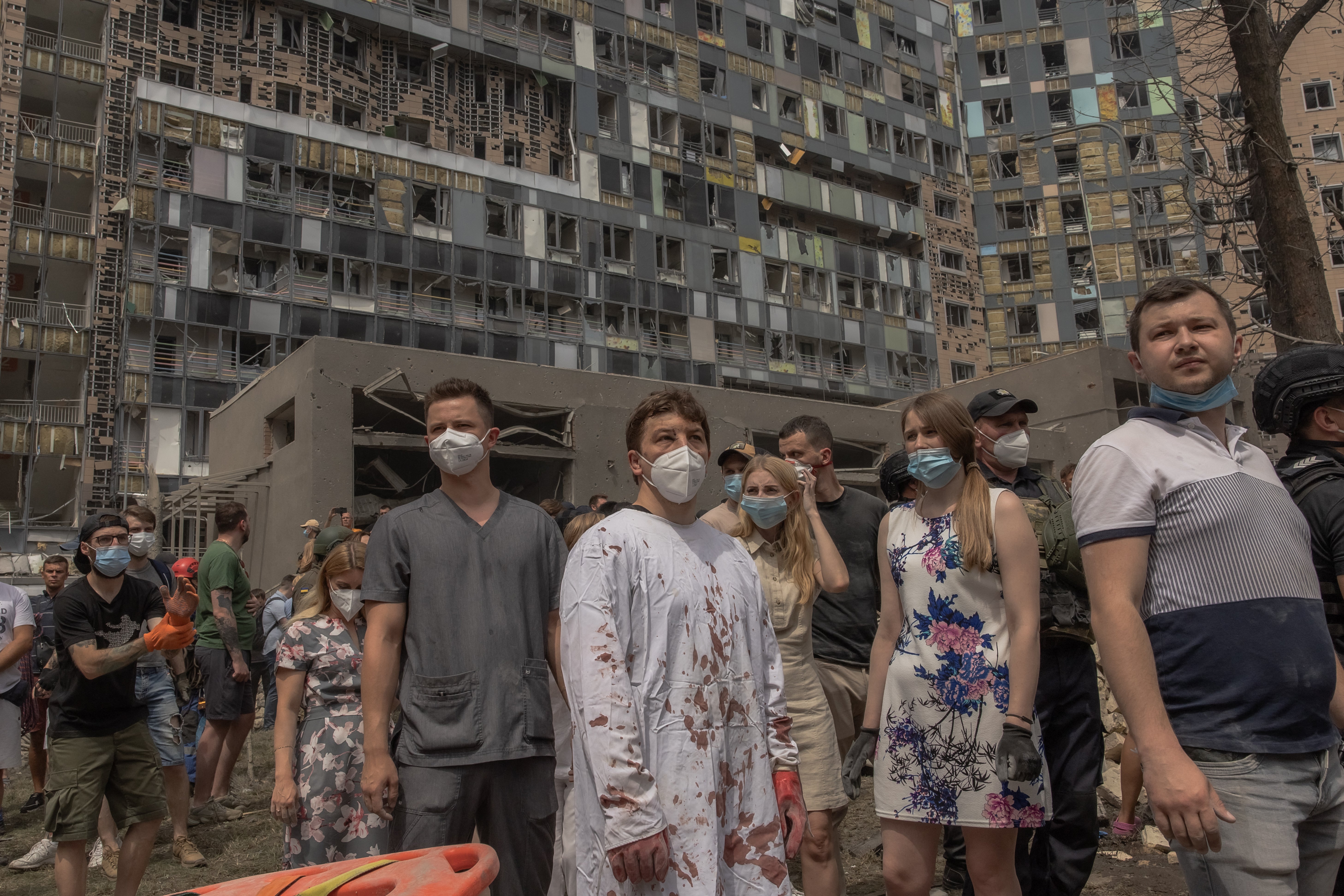 Ukrainian doctors stand amid the rubble of the destroyed building of Ohmatdyt Children’s Hospital following a Russian missile attack in the Ukrainian capital of Kyiv