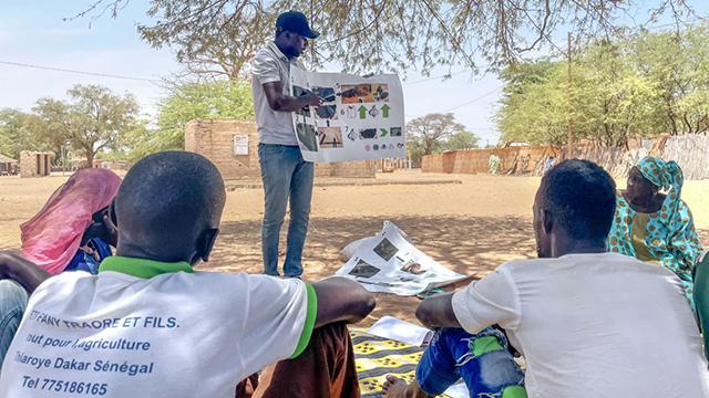 Babacar Seck, a Senegalese educator, informs a group in Syer, Senegal, on the benefits of using compost made from removed aquatic vegetation.