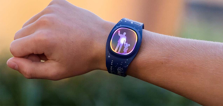 A close-up of a person's arm wearing a Disney watch