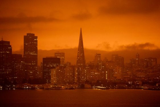 Dark orange skies hang over the San Francisco skyline seen from Treasure Island.