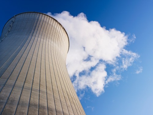 Cooling tower at nuclear power plant emits steam.