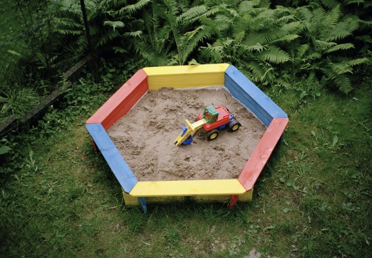 A toy truck in a sandbox