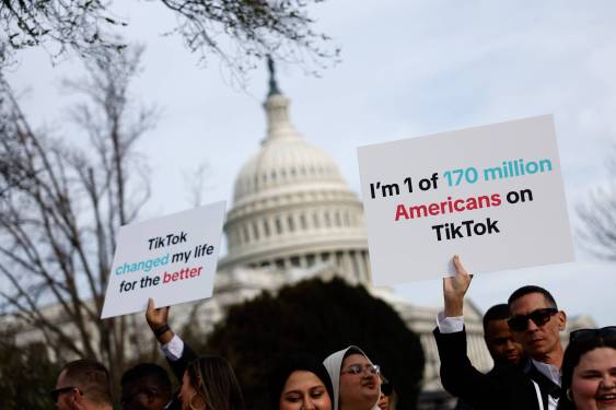 people holding signs outside US Capitol supporting TikTok