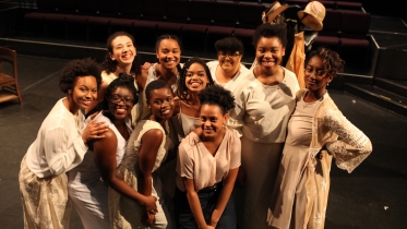 A group of students gathered together on stage.