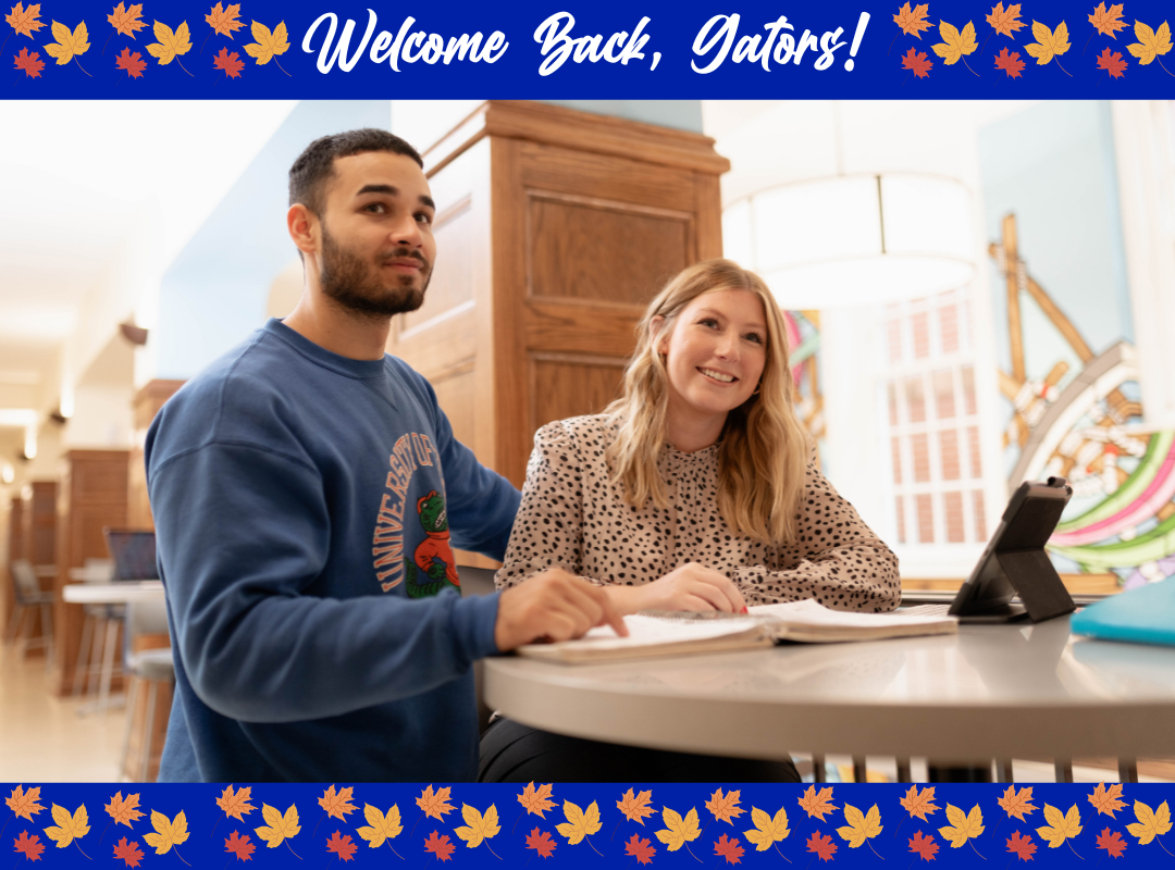 Two people smiling and studying at a table in a library, with the text “Welcome Back, Gators!” in a blue border with autumn leaves.