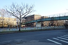 The parkway as seen from Sherman Street. In the background, there is a pedestrian bridge over Ocean Parkway.